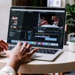 Adobe Creative Cloud - Person Using Macbook Pro on White Table