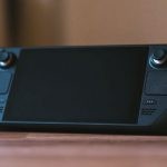 Gaming PCs - A black game controller sitting on top of a table