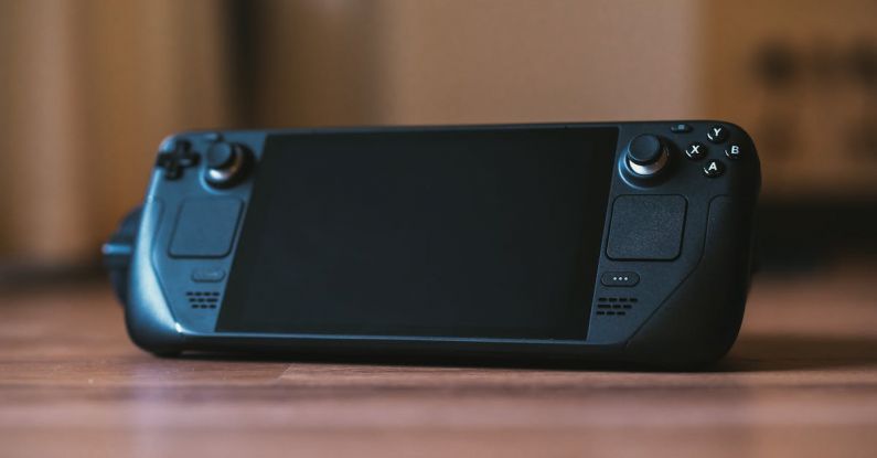 Gaming PCs - A black game controller sitting on top of a table