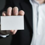 Office Suites - Close-up of Hand Holding Text over Black Background