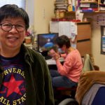 Refurbished Computers - Man in Black Framed Eyeglasses and Green and Red Pullover Hoodie