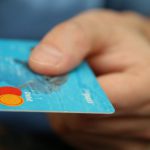 Buy - Person Holding Debit Card