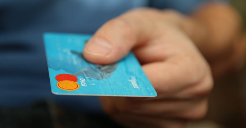Buy - Person Holding Debit Card