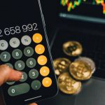 Mobile Computing - A Person Holding a Smartphone with a Calculator App on the Screen