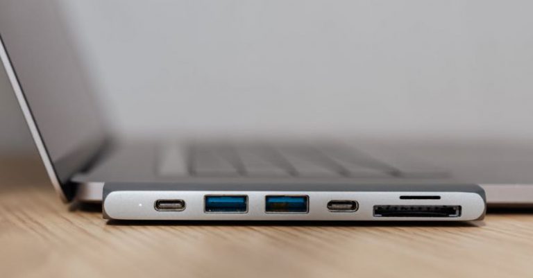 USB Hubs - Space grey type c USB hub with multiple different ports connected to laptop