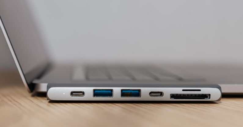 USB Hubs - Space grey type c USB hub with multiple different ports connected to laptop