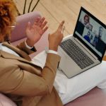 Webcam - Man Sitting on Sofa Talking on Webcam on Laptop