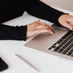 Mobile Data - Crop faceless woman working on netbook in office
