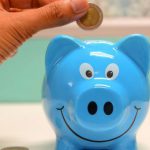 Save - Person Putting Coin in a Piggy Bank