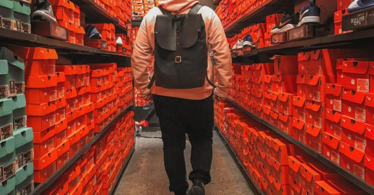 Outlet Stores - Man Wearing Backpack on Shoe Store