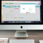 Monitor - Silver Imac, Apple Magic Keyboard, and Magic Mouse on Wooden Table